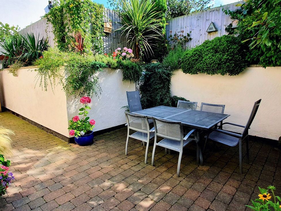 A garden area with a table and chairs at The Stables in Prestatyn