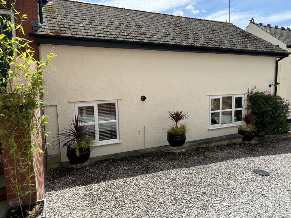 An outdoor area with plants and windows at The Stables in Prestatyn