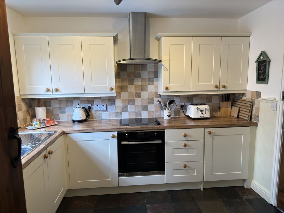A kitchen with a kettle and toaster on the counter at The Stables in Prestatyn