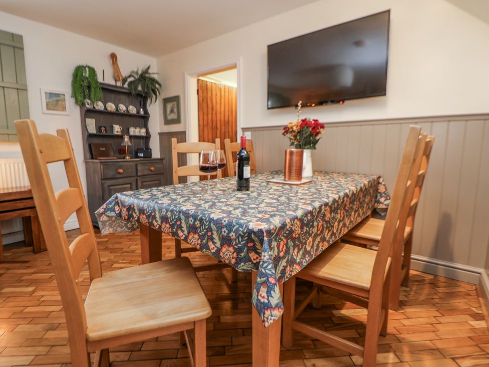 A dining room with a table and chairs at The Stables in Prestatyn