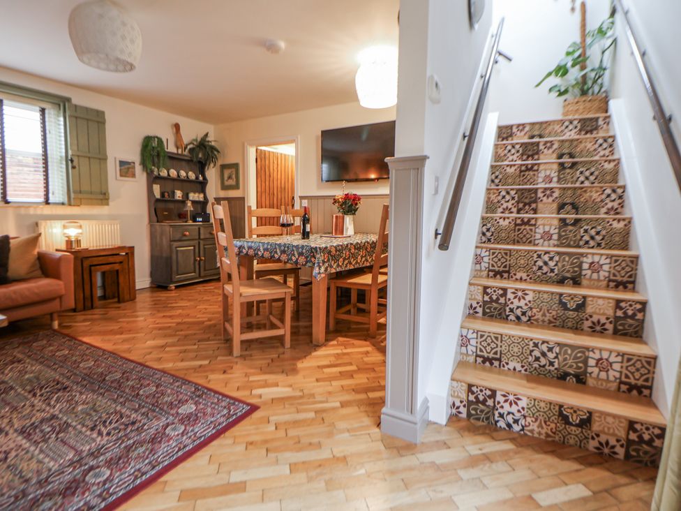 A dining room with a table and chairs at The Stables in Prestatyn