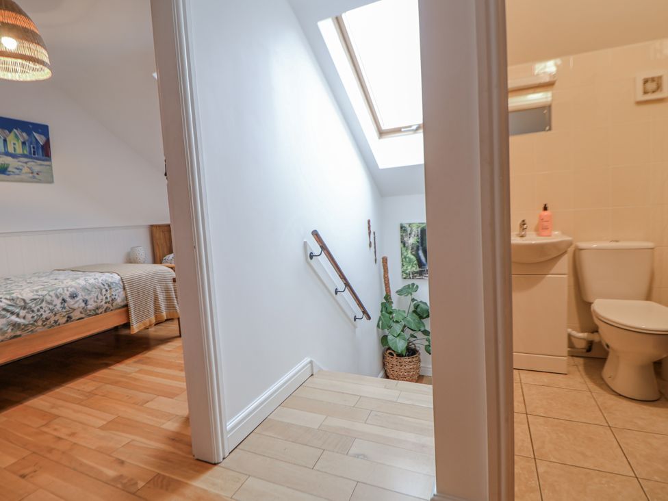 A bathroom with a toilet and sink at The Stables in Prestatyn
