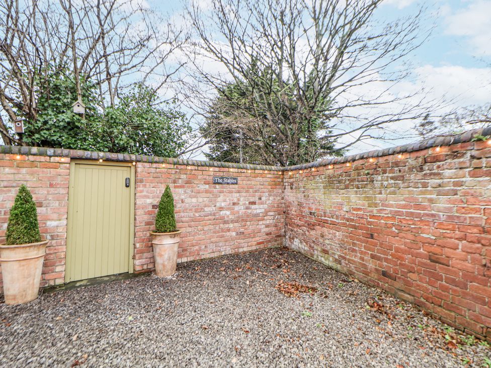 An outdoor area with a door and plants at The Stables in Prestatyn