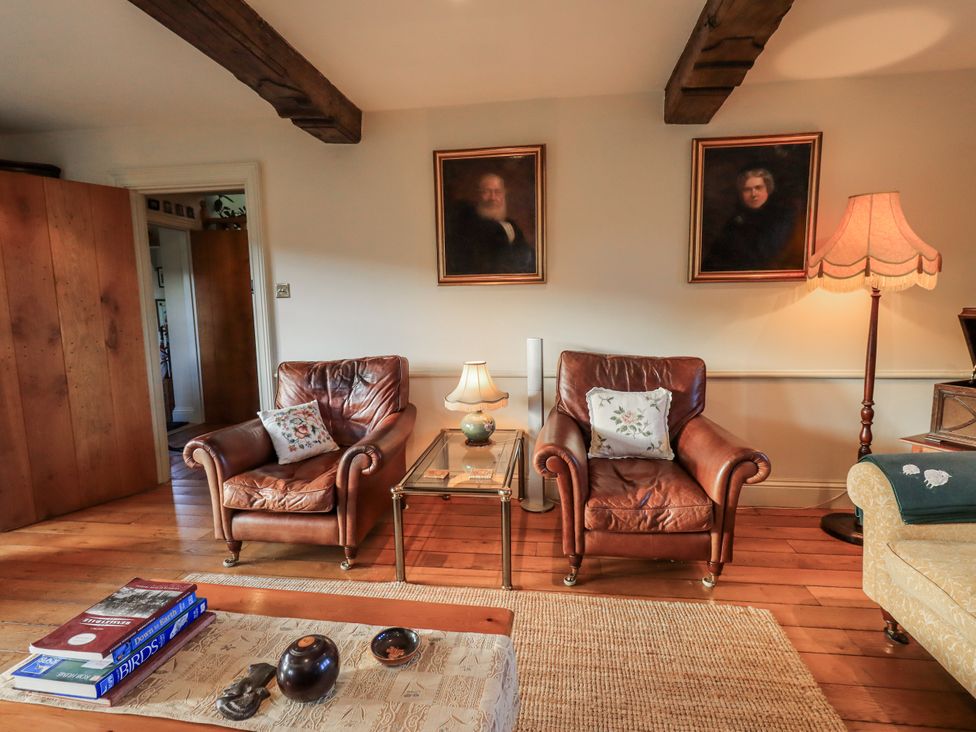 A living room with two armchairs and a table at Orchard House in Leyburn