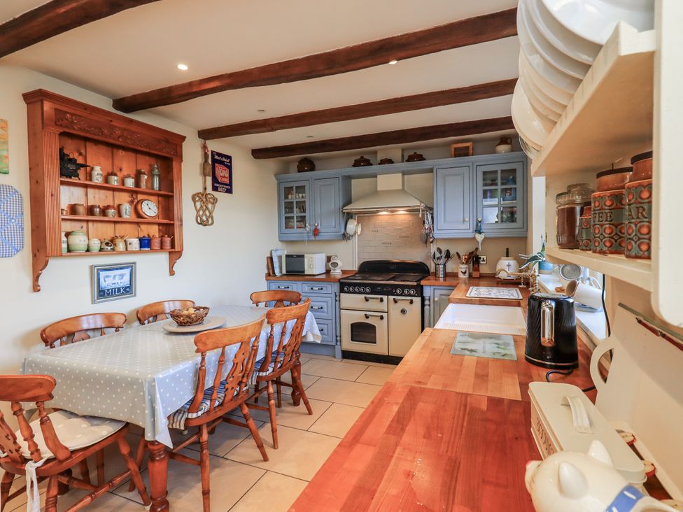 A kitchen with a table and chairs at Orchard House in Leyburn