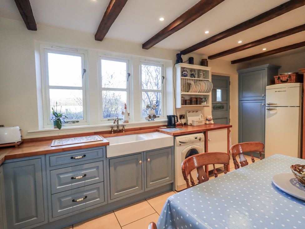 A kitchen with a sink and appliances at Orchard House Leyburn