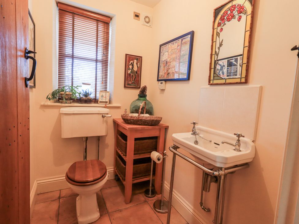 A bathroom with a toilet and sink at Orchard House Leyburn