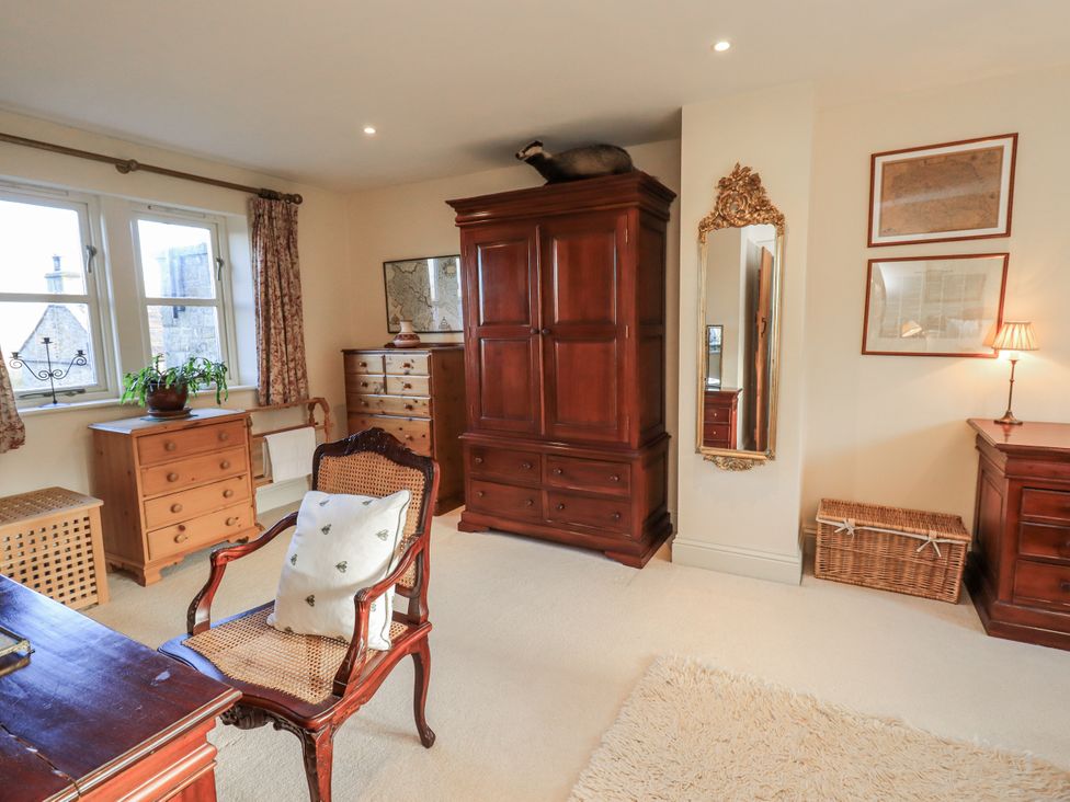 A bedroom with a desk and armoire at Orchard House in Leyburn