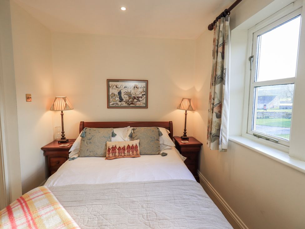 A bedroom with a bed and nightstand at Orchard House Leyburn