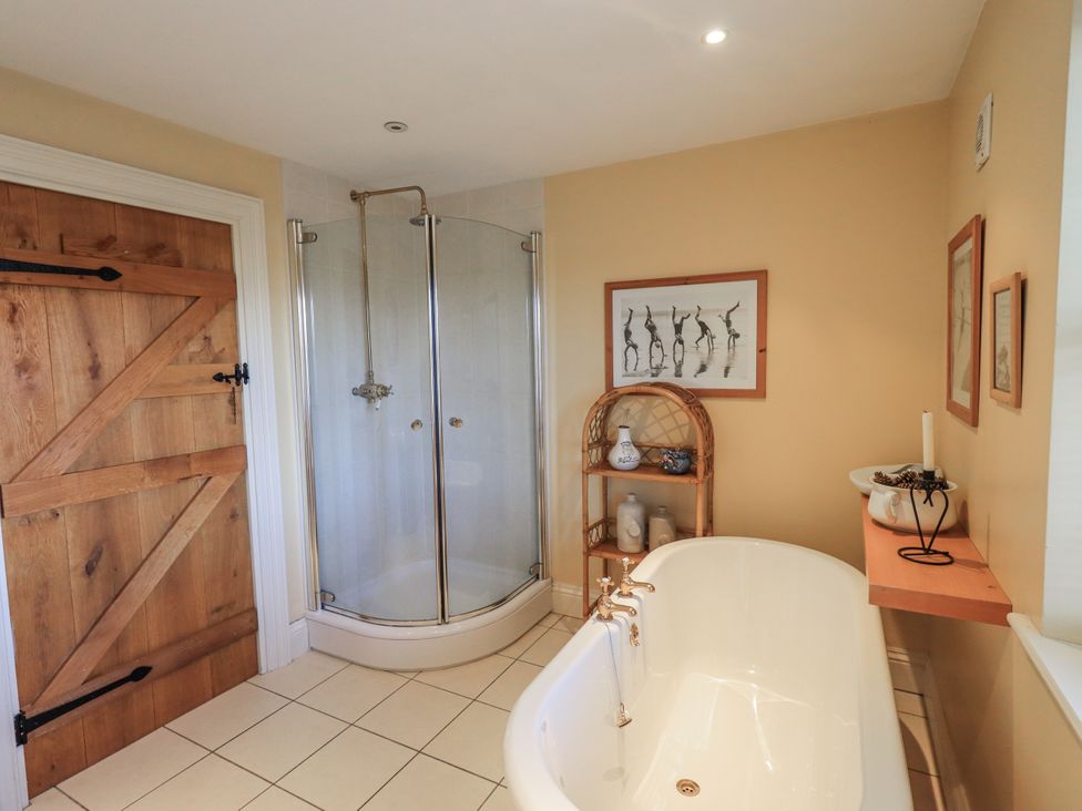 A bathroom with a shower and bathtub at Orchard House in Leyburn