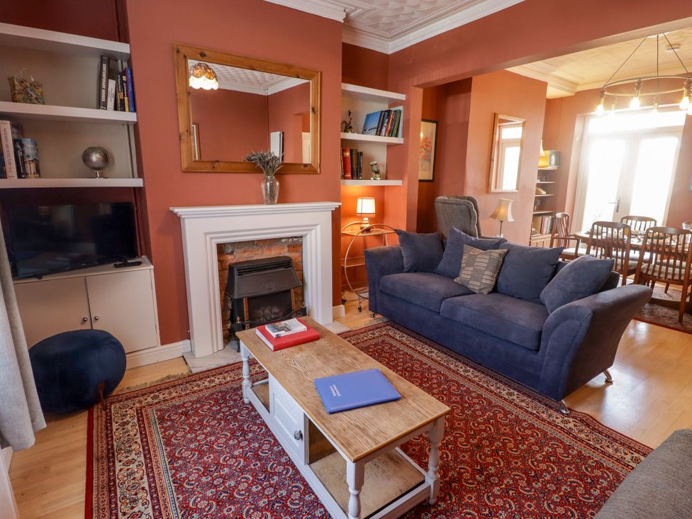 A living room with a sofa, coffee table, and television at 18 Kent Street Cardiff