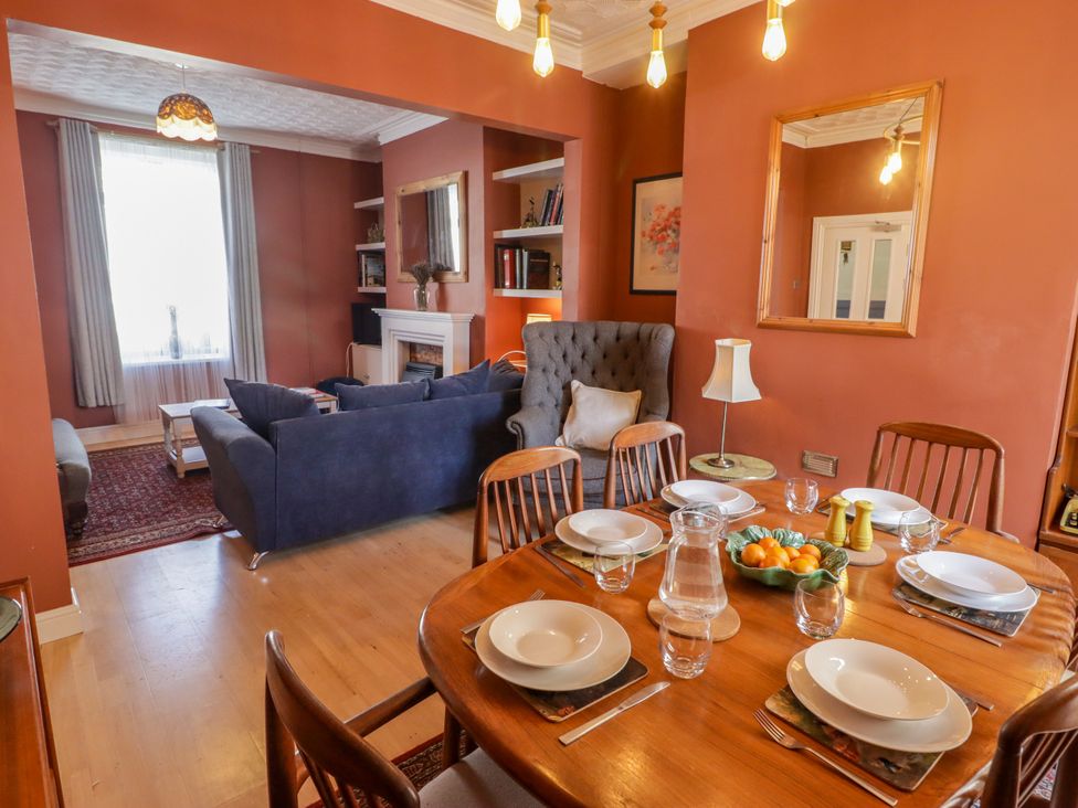 A dining room with a table set for meals at 18 Kent Street Cardiff
