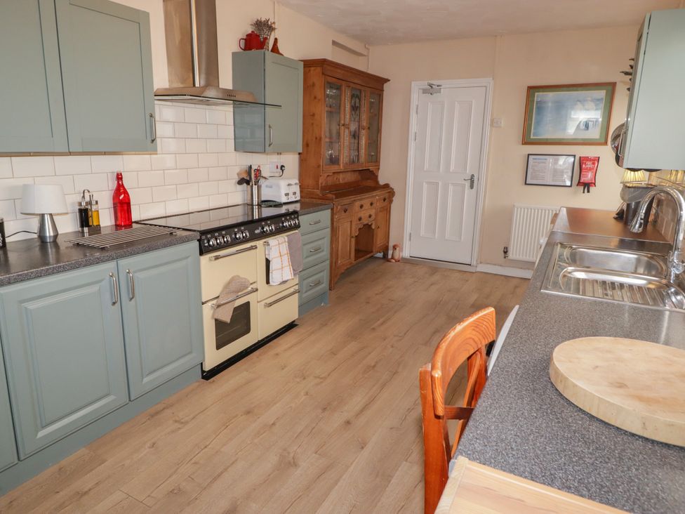 A kitchen with cabinets and a stove at 18 Kent Street Cardiff