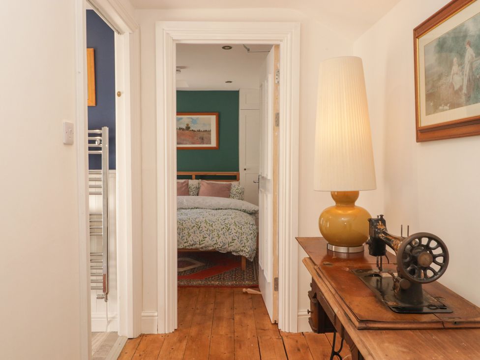 A hallway with a bed visible in the background at 18 Kent Street in Cardiff