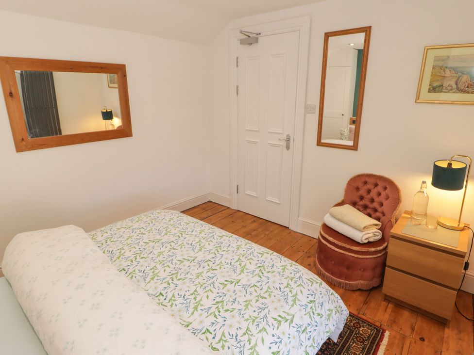 A bedroom with a bed and a nightstand at 18 Kent Street Cardiff