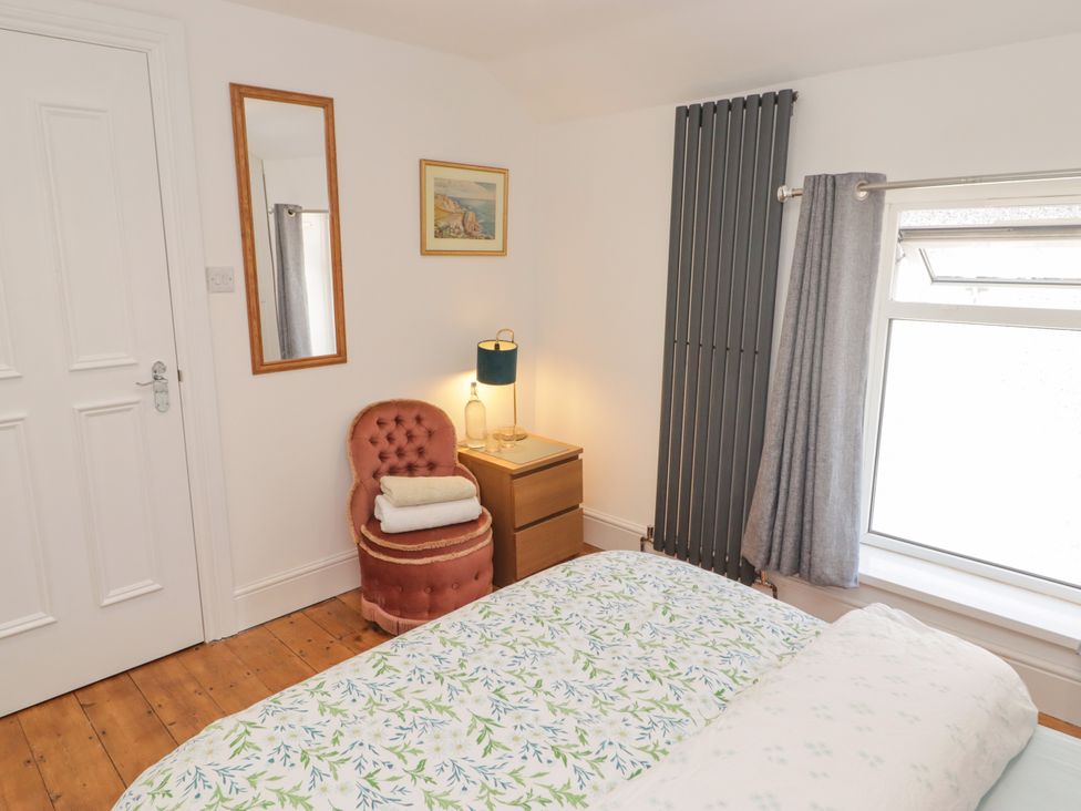 A bedroom with a bed and chair at 18 Kent Street in Cardiff