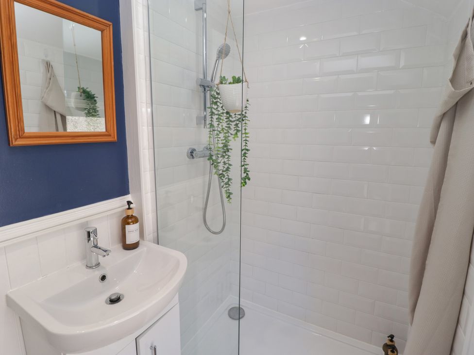 A bathroom with a shower and sink at 18 Kent Street in Cardiff