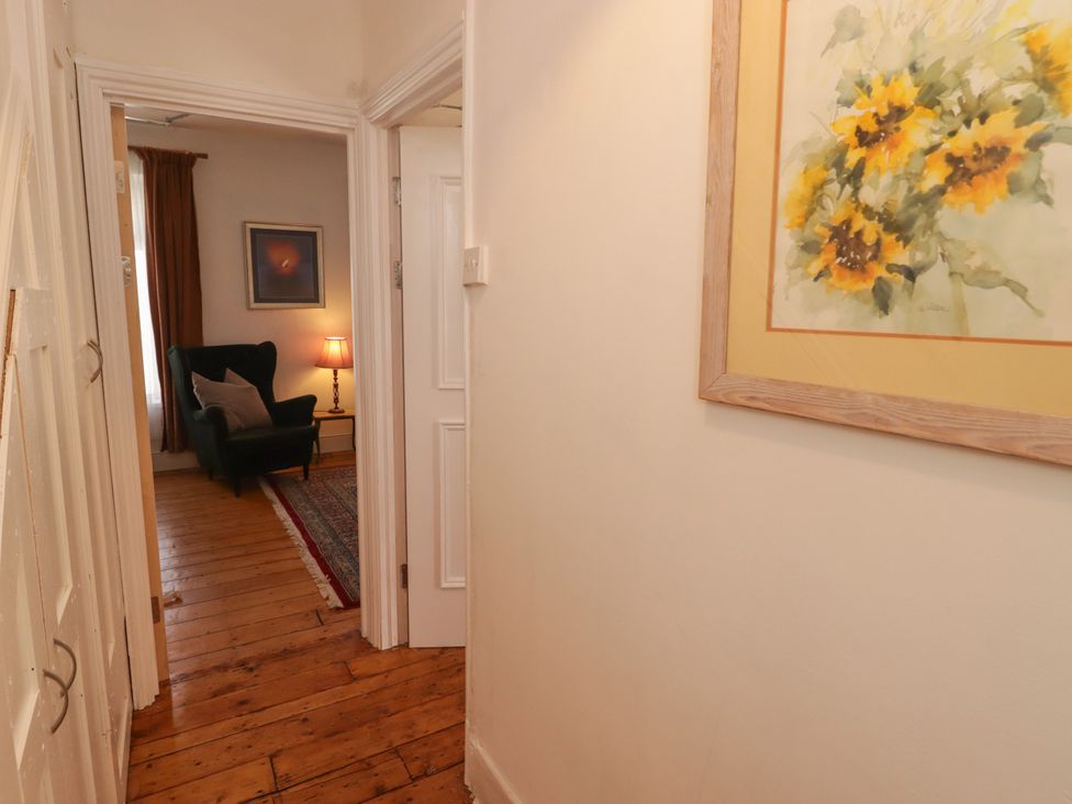 A hallway with a sofa, lamp and painting at 18 Kent Street Cardiff