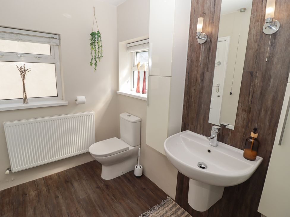 A bathroom with a toilet and sink at 18 Kent Street Cardiff