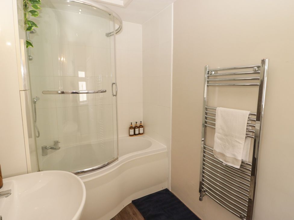 A bathroom with a shower and bathtub at 18 Kent Street Cardiff