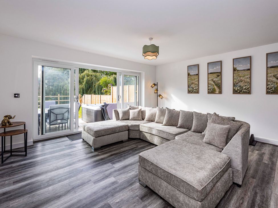 A living room with a sofa and dining set at 2 Riverside Mews in Derby