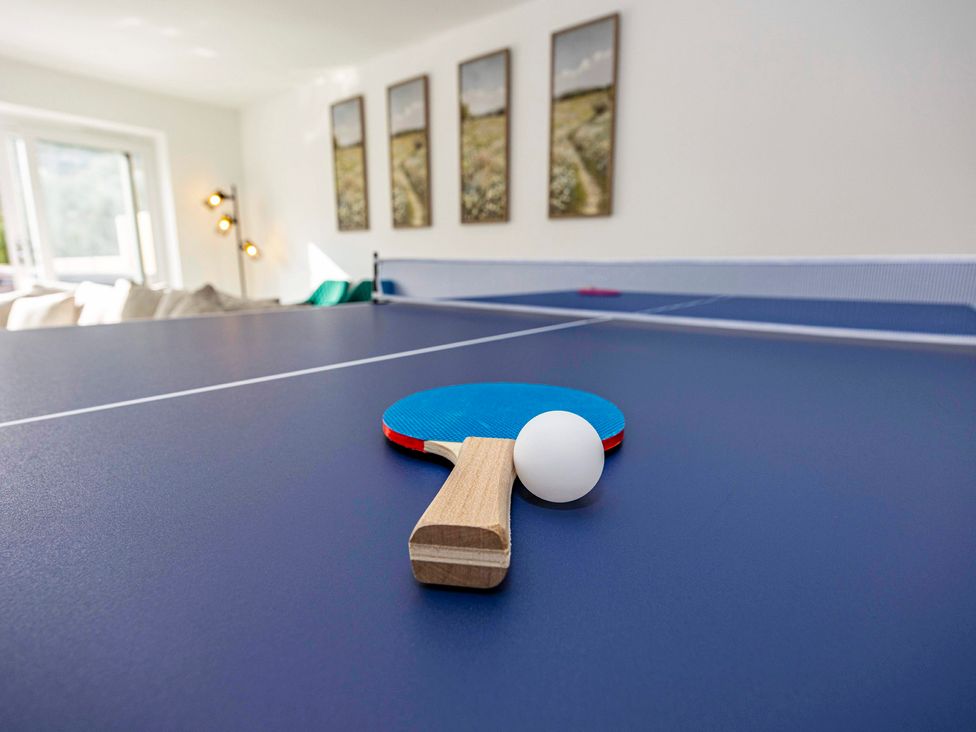 A table tennis setup with a paddle and ball at 2 Riverside Mews, Derby