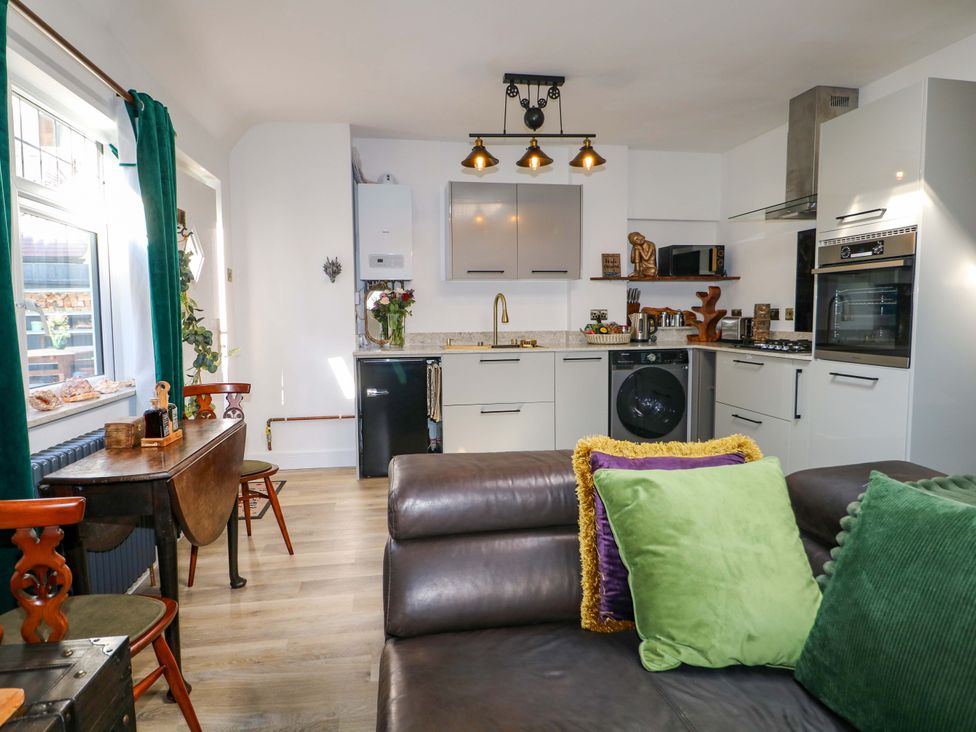 A kitchen with cabinets and appliances at Shell Cottage Bournemouth