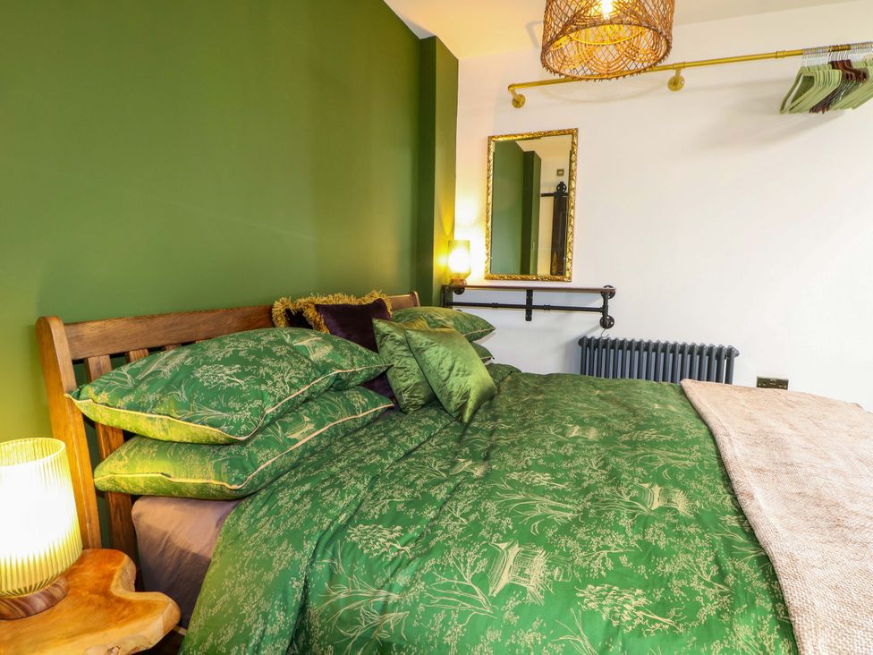 A bedroom with a bed and pillows at Shell Cottage in Bournemouth