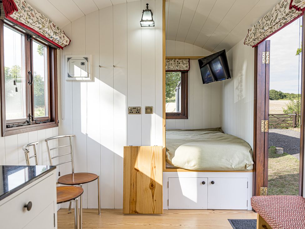 A bedroom with a bed and television at No 1 The Orchard, Upton Warren