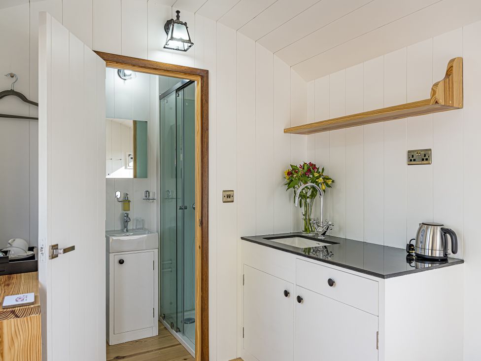 A kitchenette with a sink and kettle at No 1 The Orchard in Upton Warren