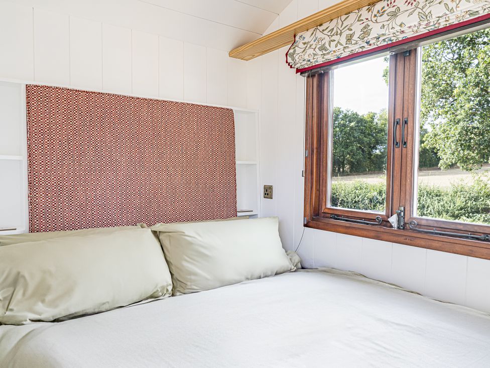 A bedroom with a bed and window at No 1 The Orchard Upton Warren