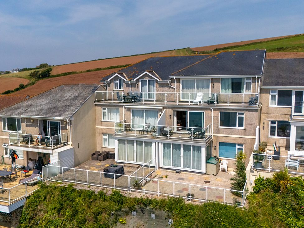 A building with balconies and patio at 6 Avon Quillet in Bigbury-On-Sea