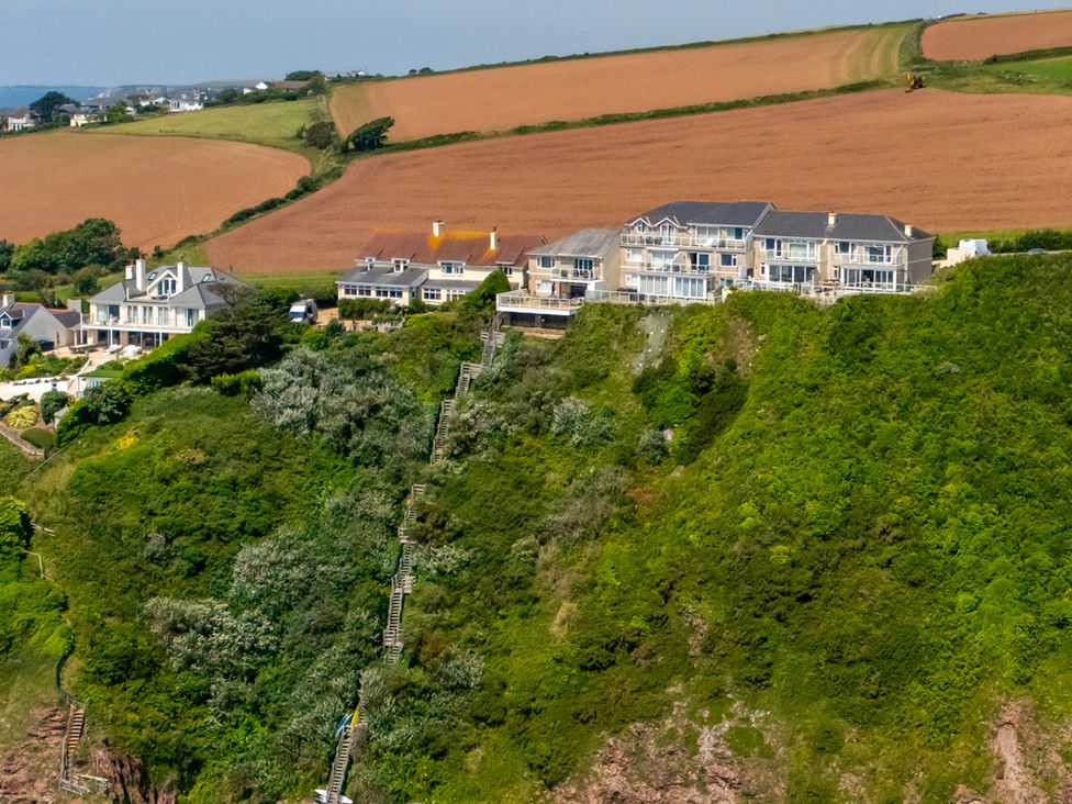 A landscape with houses and stairs on a hillside at 6 Avon Quillet Bigbury-On-Sea