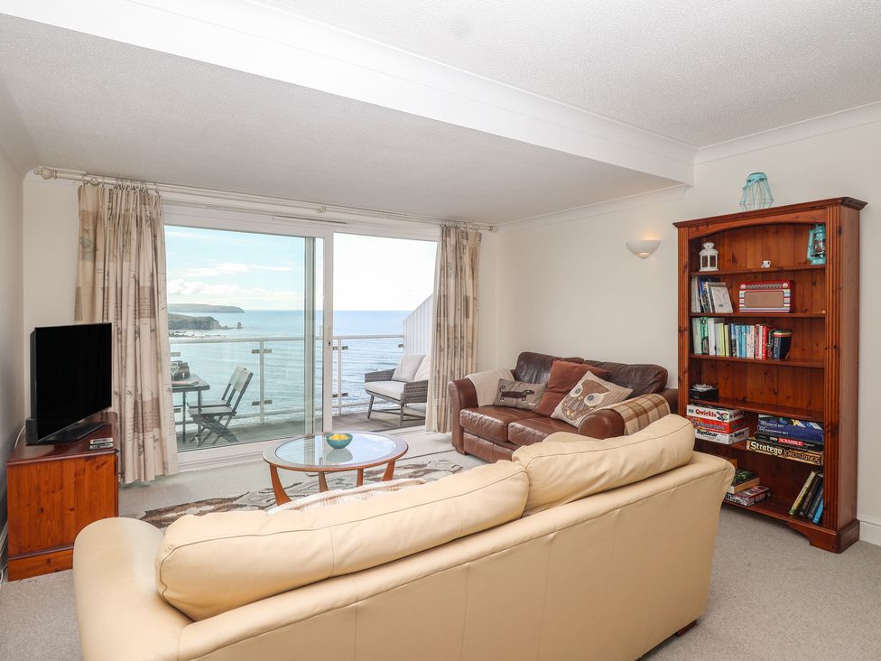 A living room with a view of the sea and furniture at 6 Avon Quillet in Bigbury-On-Sea