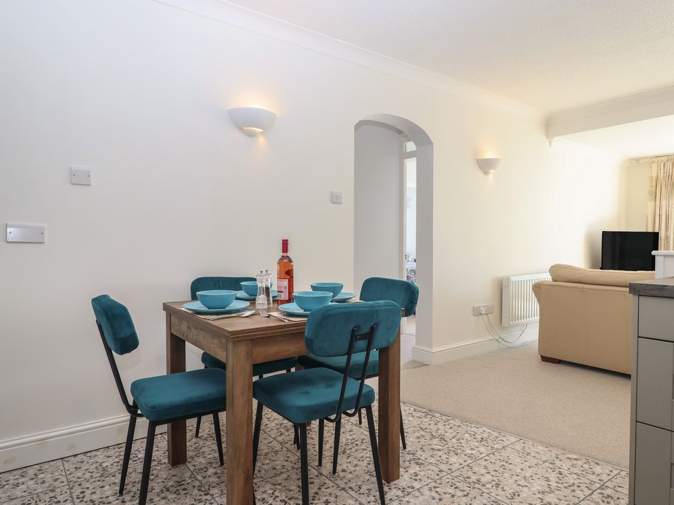 A dining room with a table set for four at 6 Avon Quillet Bigbury-On-Sea