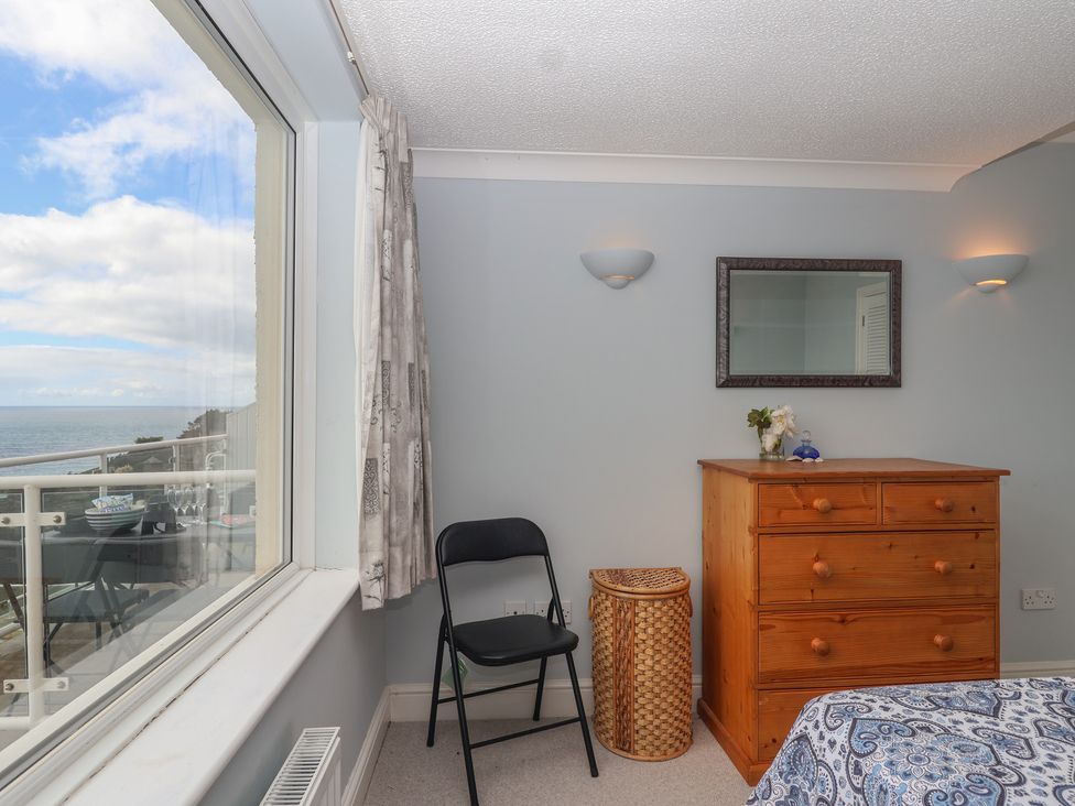A bedroom with a dresser and a chair at 6 Avon Quillet Bigbury-On-Sea