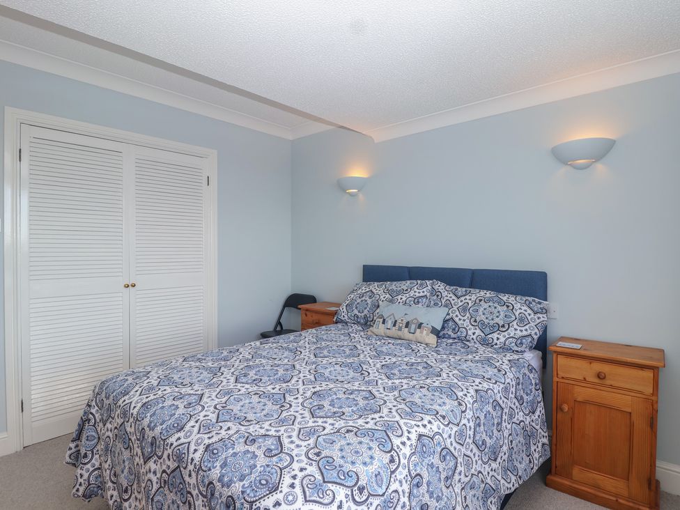 A bedroom with a bed and nightstands at 6 Avon Quillet in Bigbury-On-Sea
