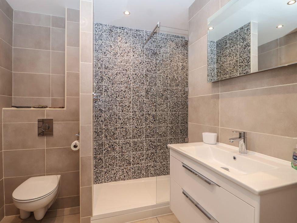 A bathroom with a shower and sink at 6 Avon Quillet in Bigbury-On-Sea