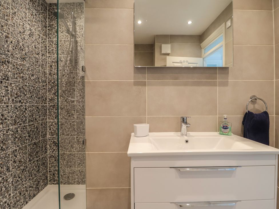 A bathroom with a shower and sink at 6 Avon Quillet Bigbury-On-Sea