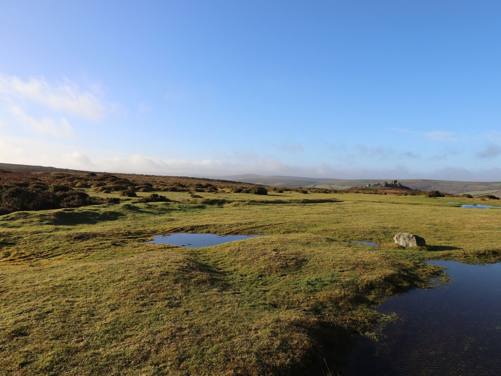A landscape with grassland and water pools at Swallows Nest in Widecombe-in-the-Moor near Postbridge