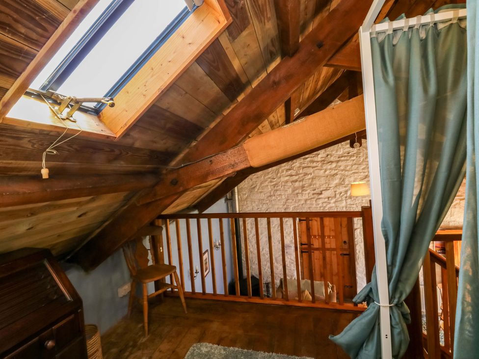A loft with skylight and wooden beams at Swallows Nest in Widecombe-in-the-Moor near Postbridge