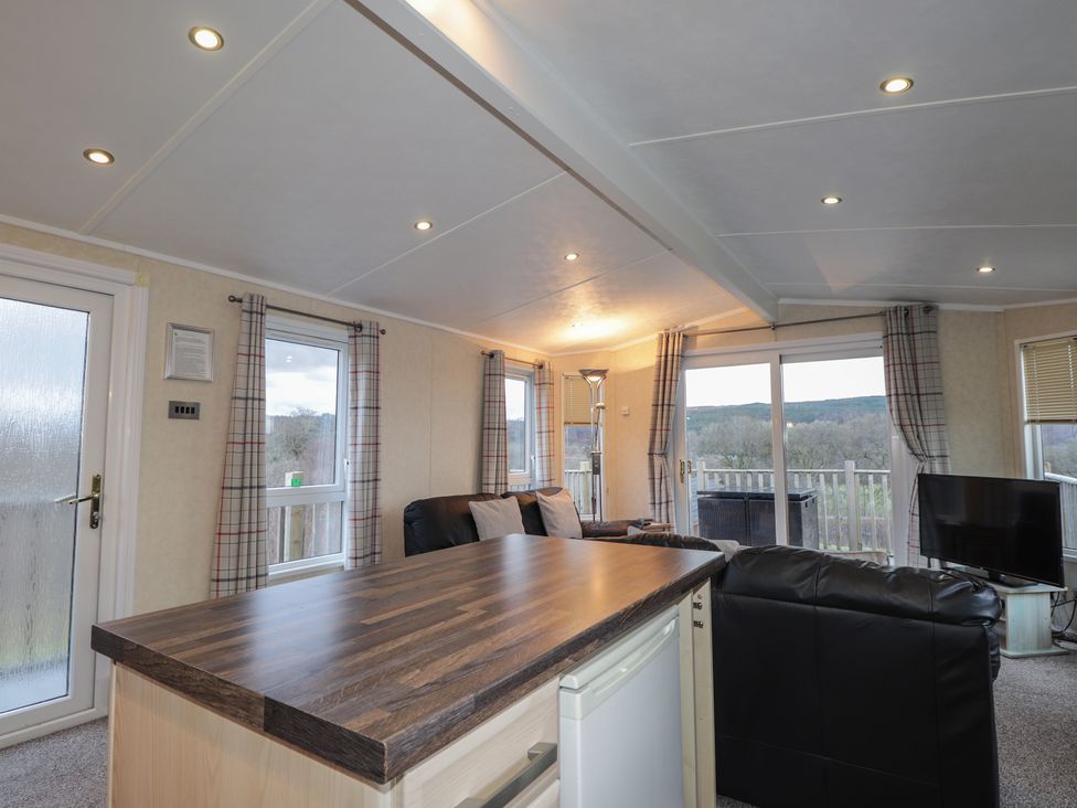 A living room with a sofa and a table at Coll in Fort William