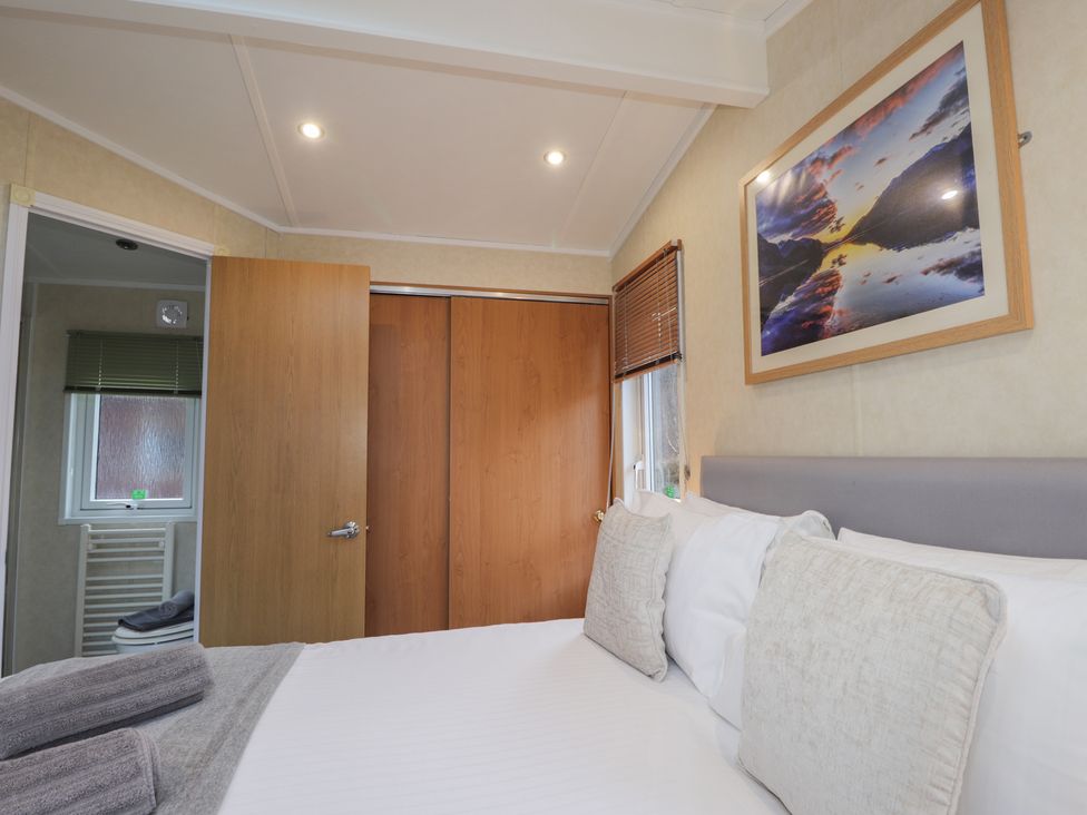 A bedroom with a bed and door at Coll in Fort William