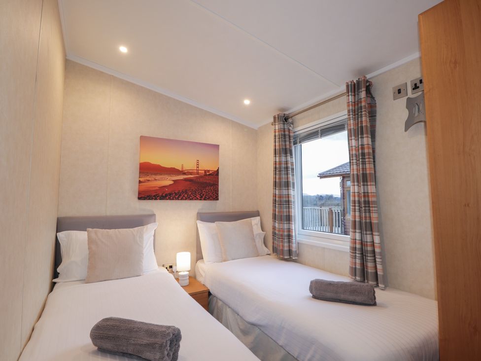 A bedroom with two beds and a window at Coll in Fort William