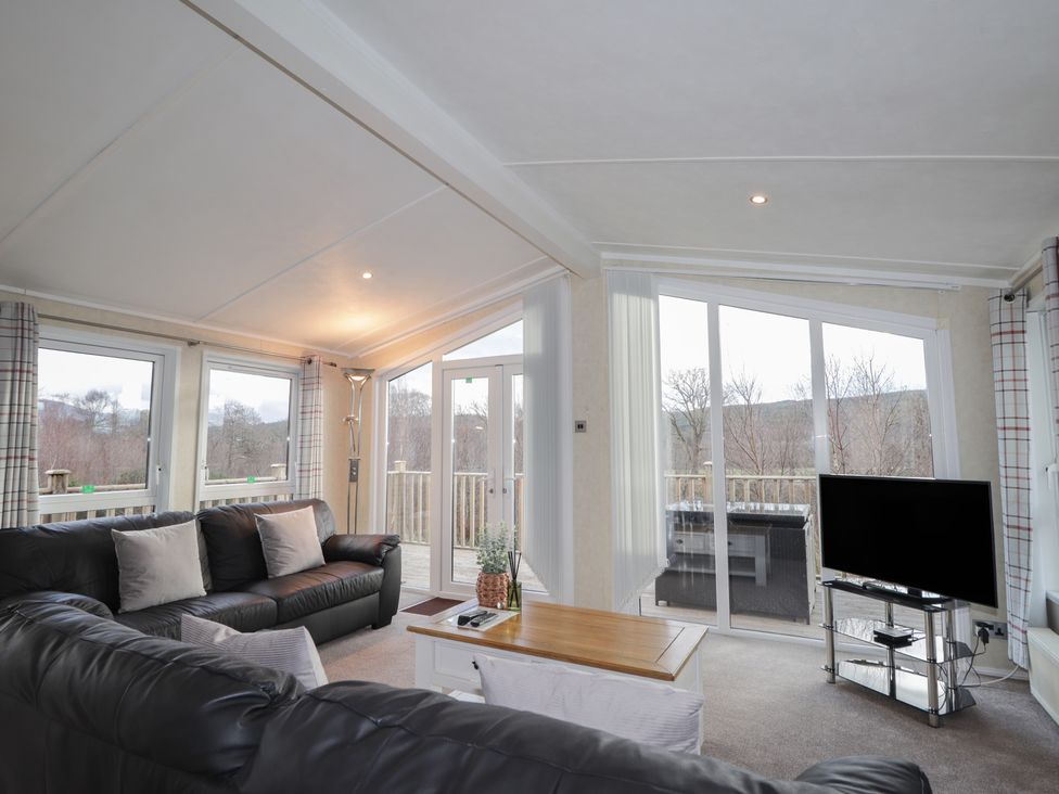 A living room with a sofa and a television at Monach 2 in Fort William