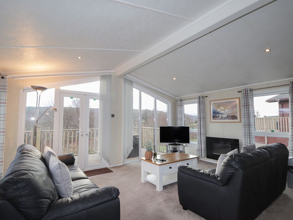 A living room with sofas and a television at Monach 2 in Fort William