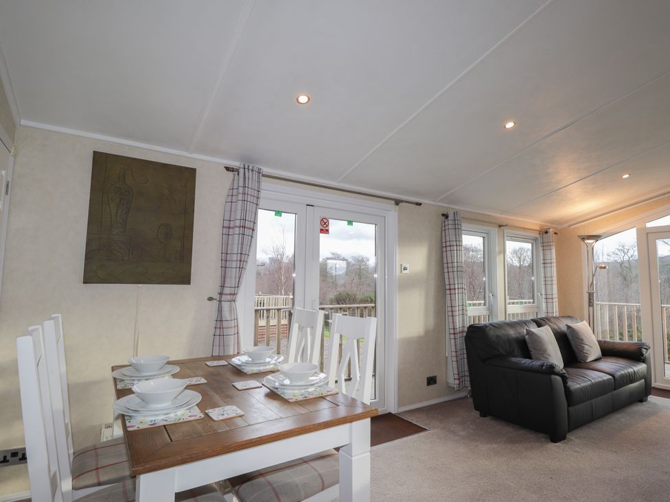 A dining room with a table and chairs at Monach 2 in Fort William