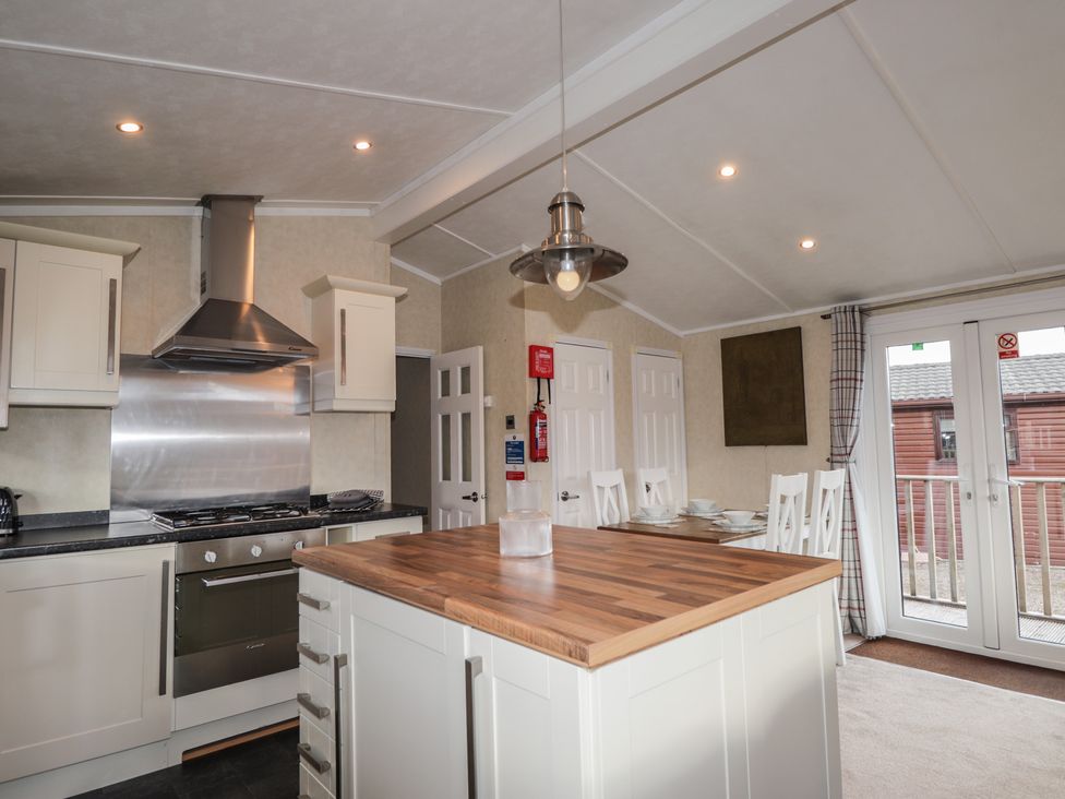 A kitchen with an island and modern appliances at Monach 2 Fort William