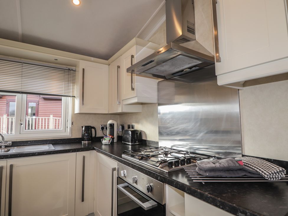 A kitchen with a gas stove and kitchen sink at Monach 2 in Fort William