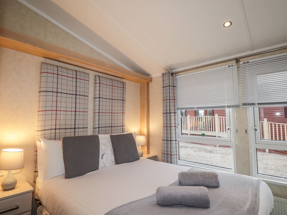 A bedroom with a bed and window at Monach 2 in Fort William